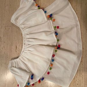 White top with pom poms